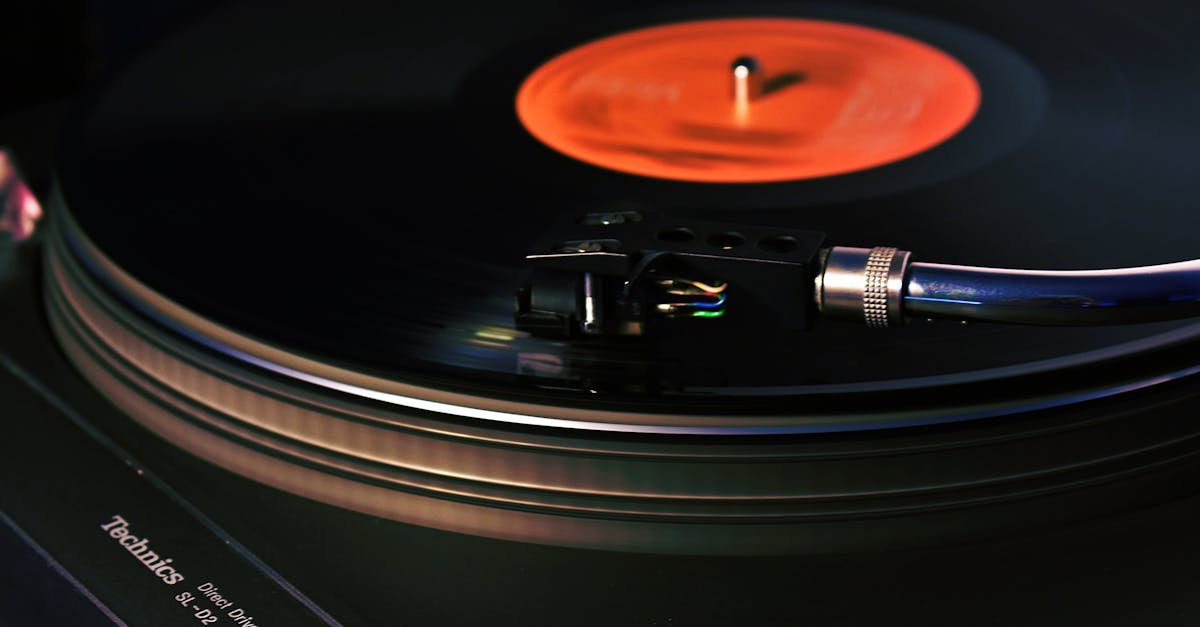 Close-up image of a vintage turntable playing a vinyl record, showcasing analog technology.